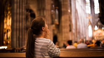 Young girl praying church